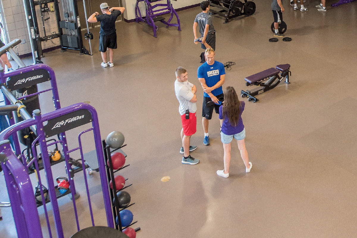 Personal trainers and students at the gym.