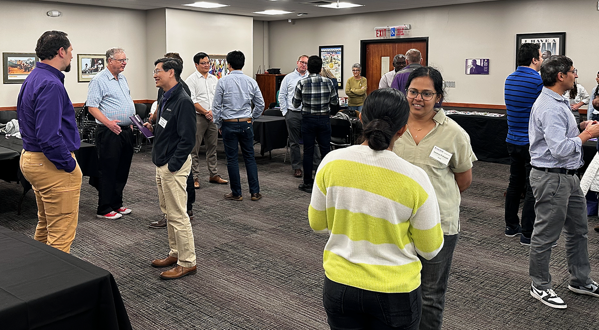 A group of people with name tags mingle