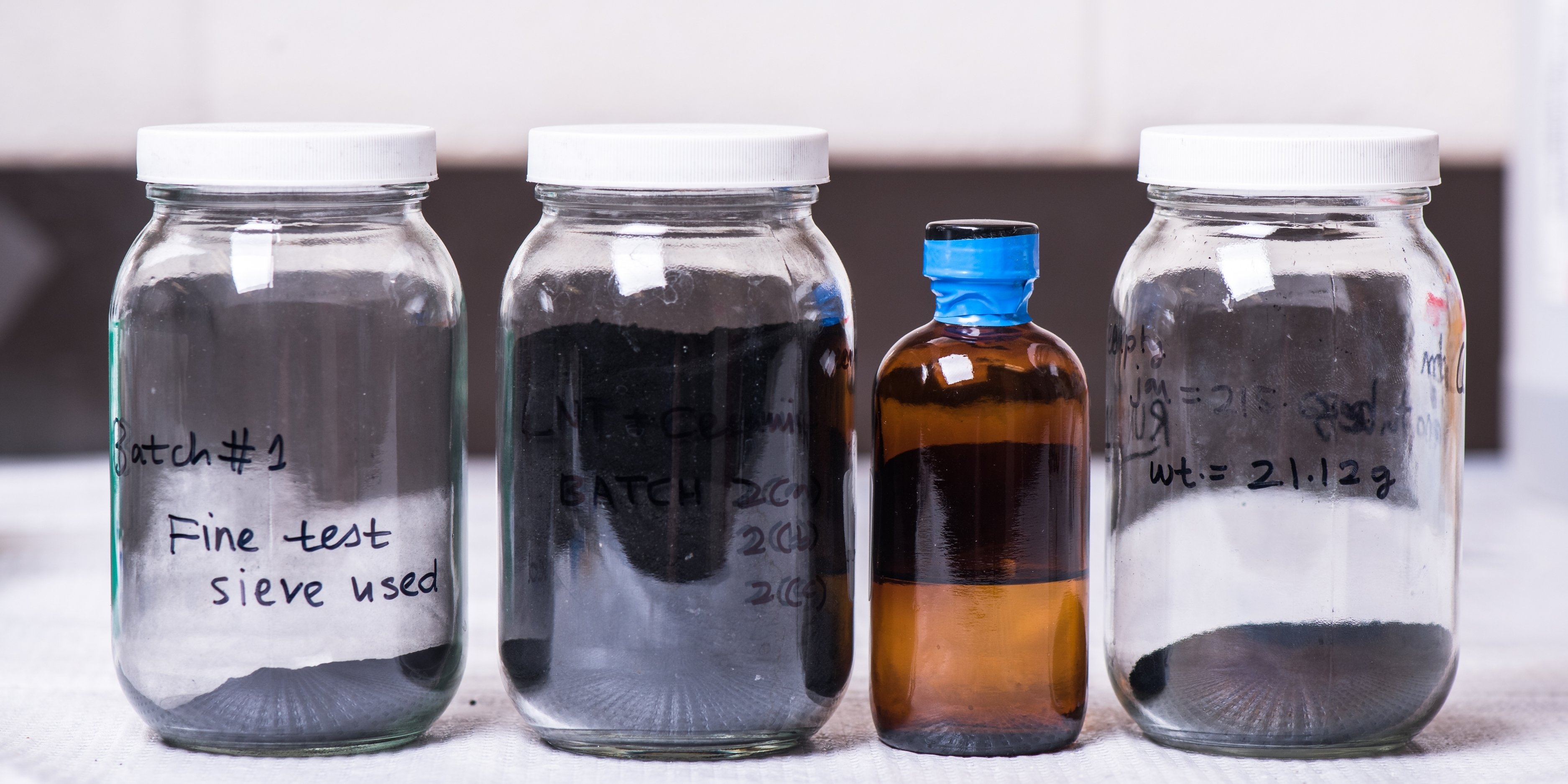 These jars show variations of a Kansas State University-patented liquid polymer that looks like water and has the same density and viscosity as water. The polymer becomes a ceramic when heated and can be mass-produced.