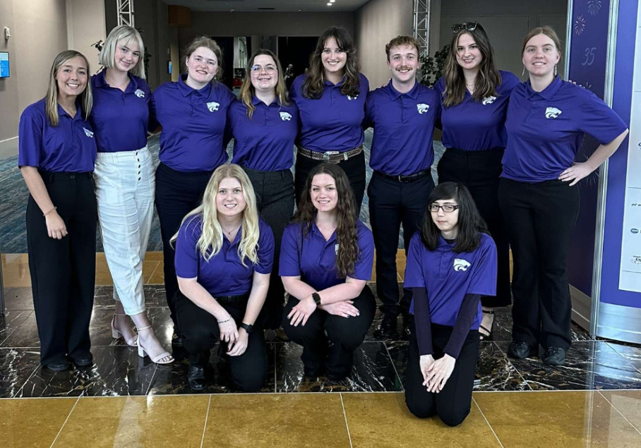 Women in Aviation group A group of students, mostly women, lined up in purple polos.