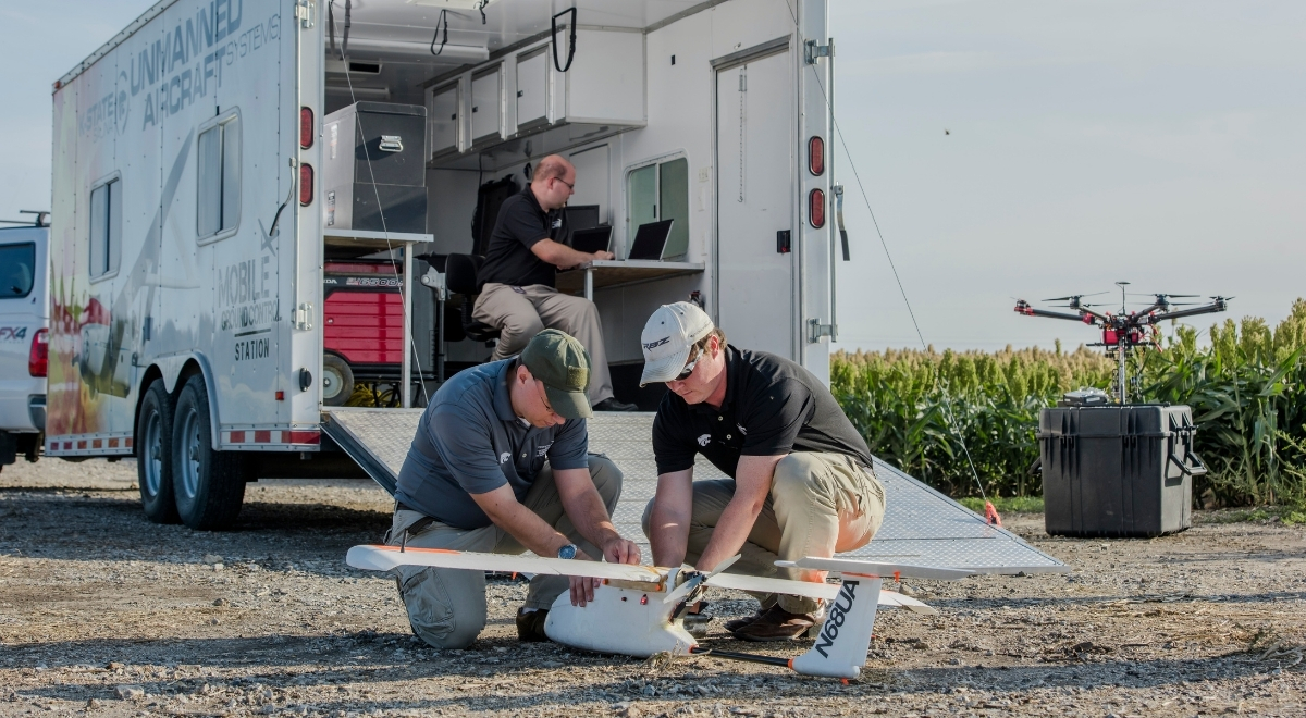 Two men working on an uncrewed aircraft system