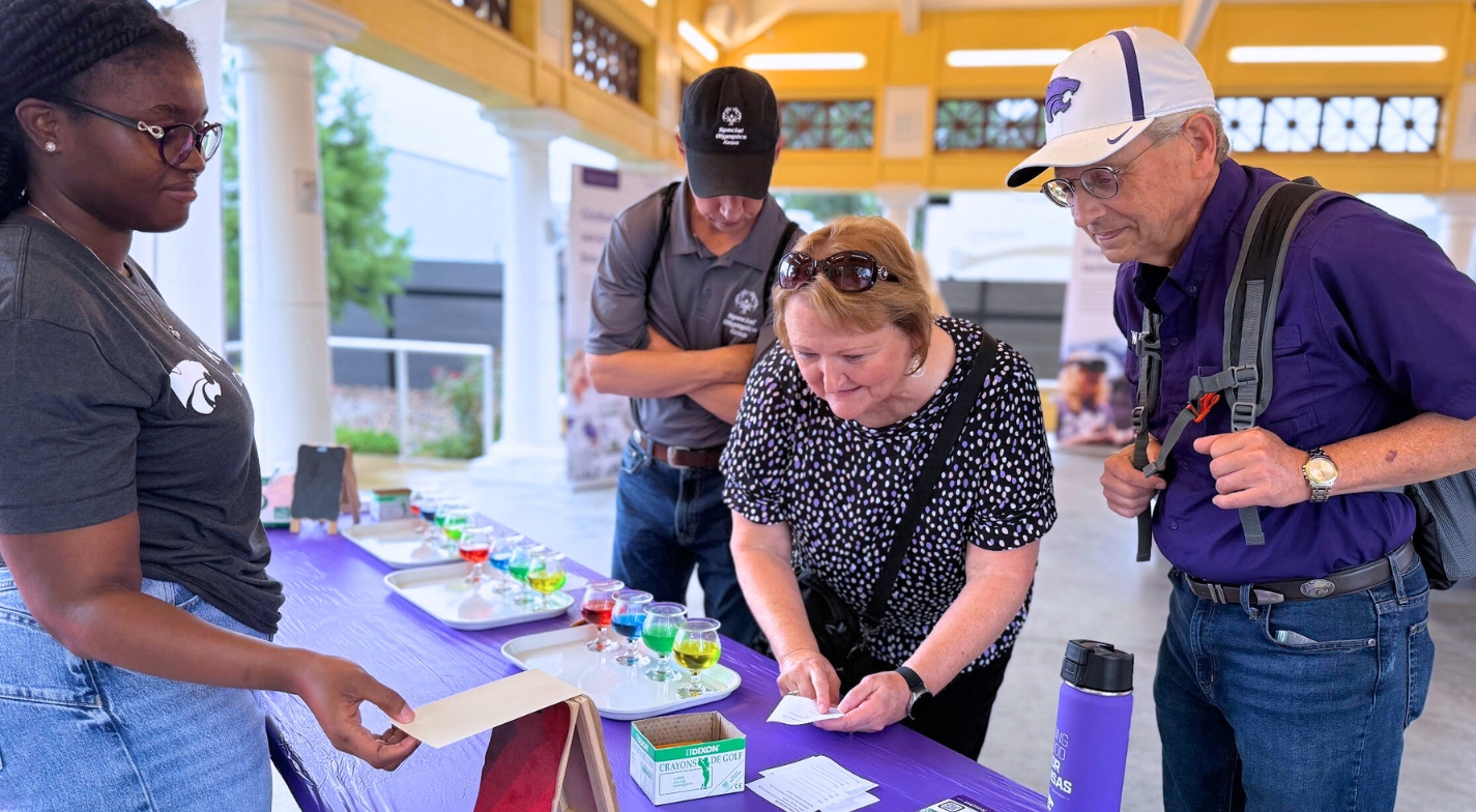 A woman works to match scent lineup to chart during an interactive booth at the Kansas State Fair