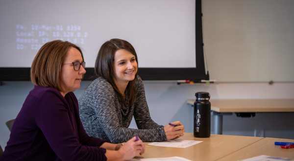 OEIE team members chatting at a table