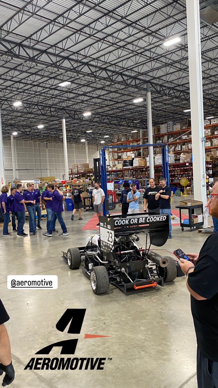 Image of the team at the Aeromotive shop with the car