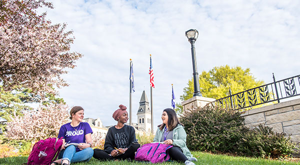 Students hanging out near WWII Memorial in front of Anderson Hall