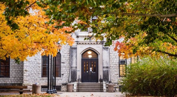 campus building with fall leaves