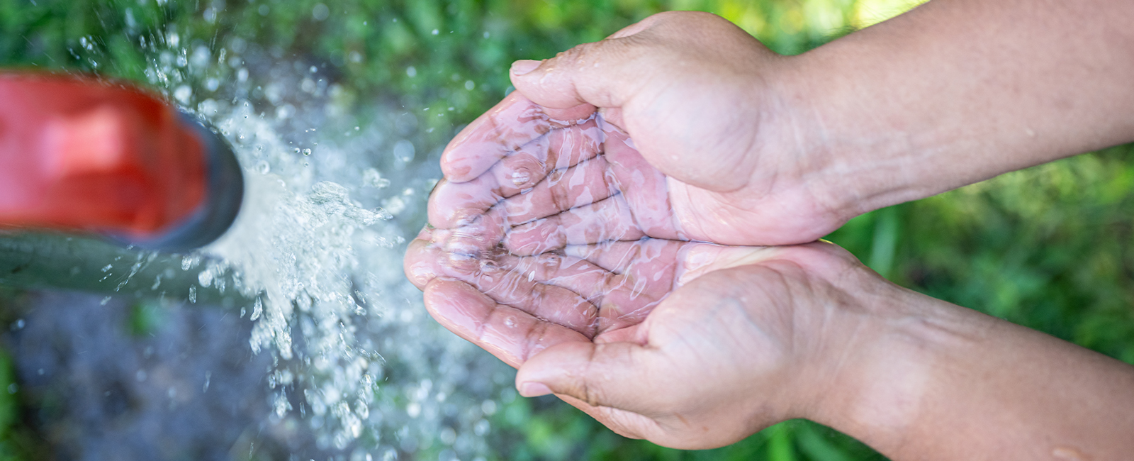 Water flowing into an individual's hands